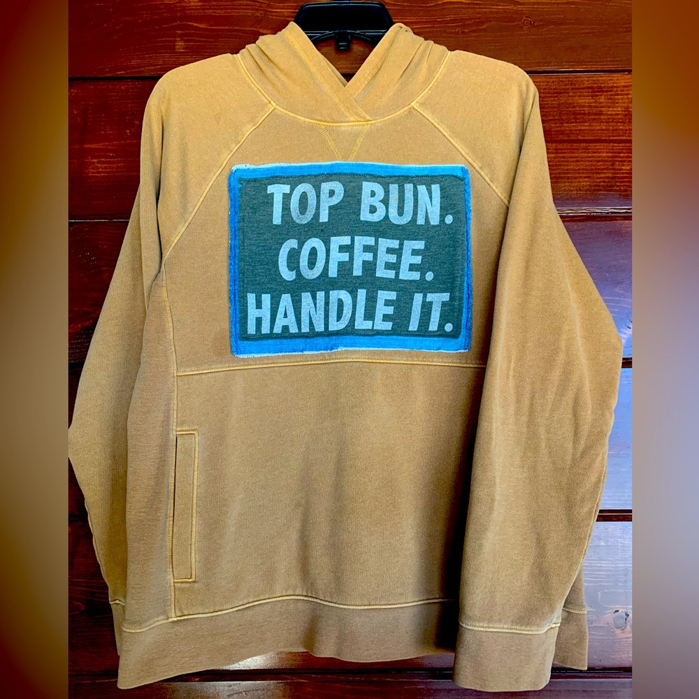 Women’s size small tan hoodie with front pocket.